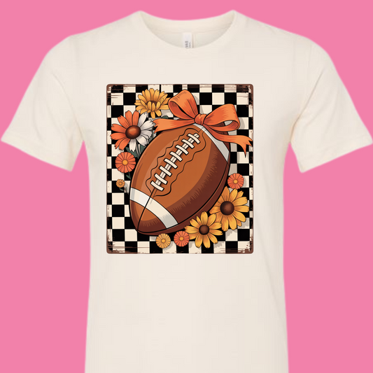 Tan t-shirt with a football and floral design on a checkered background